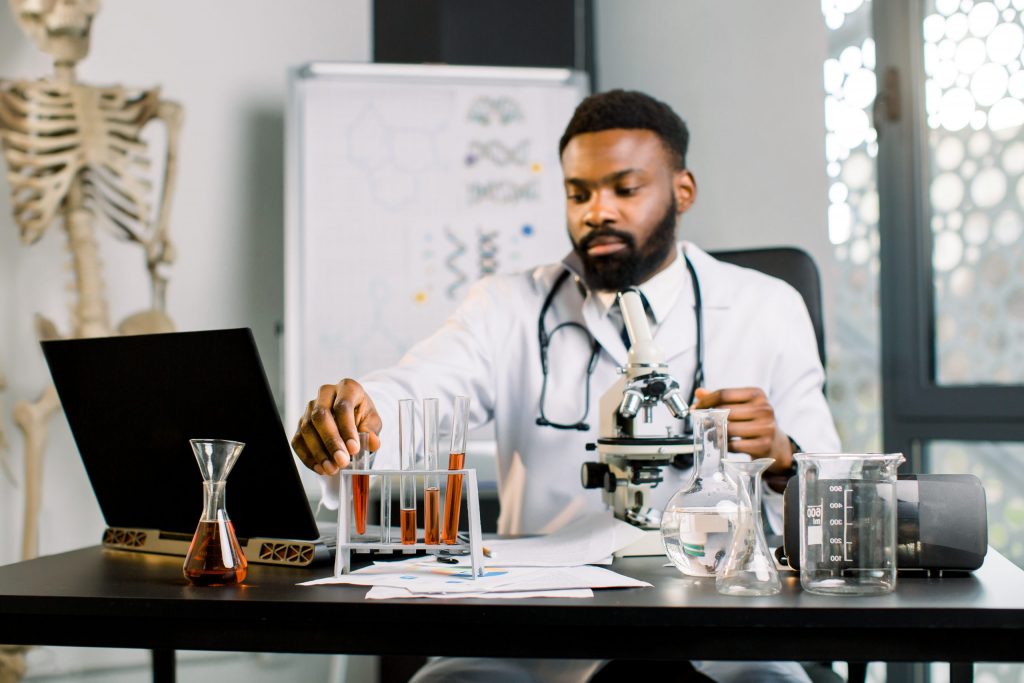 african man scientist researcher sitting at the ta       utc scaled